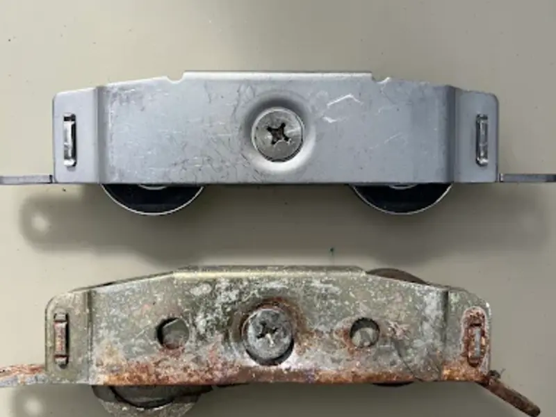 Comparison of a new roller and a corroded old sliding door roller