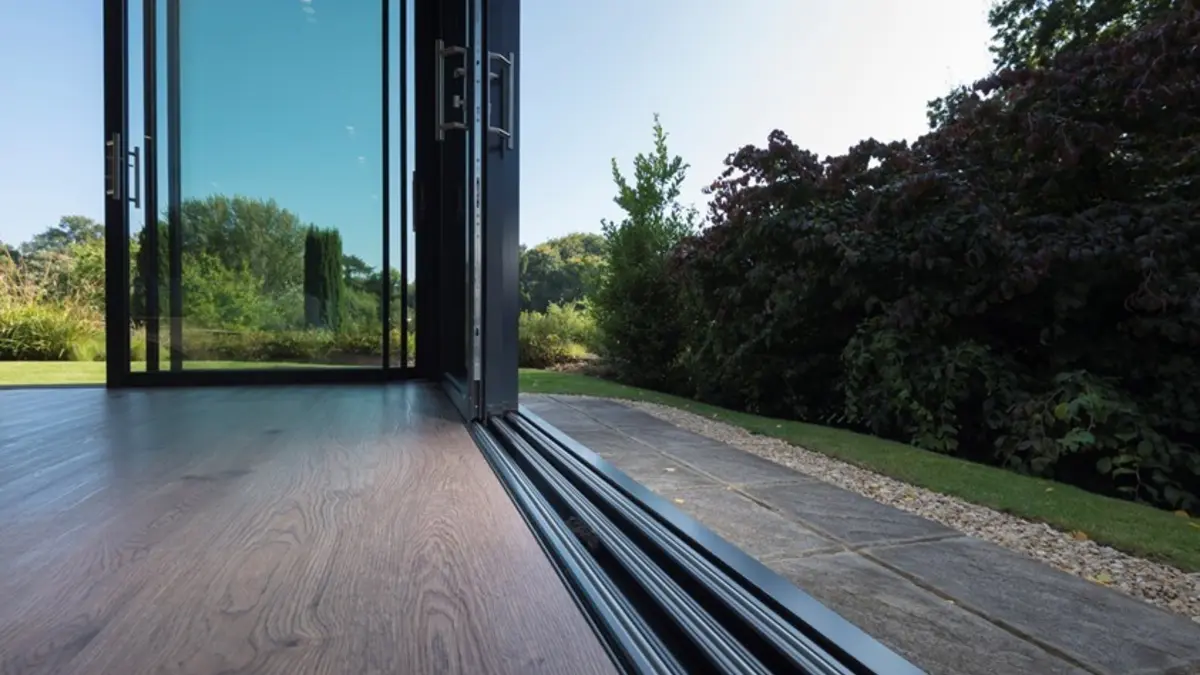 An open sliding door track being maintained at a coastal home