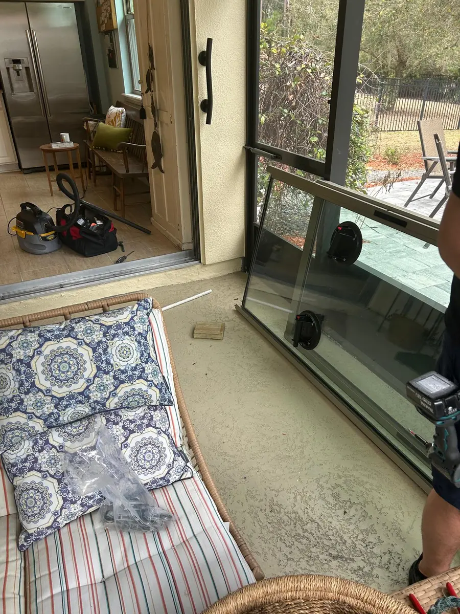 Technician inspecting a sliding glass door from the interior