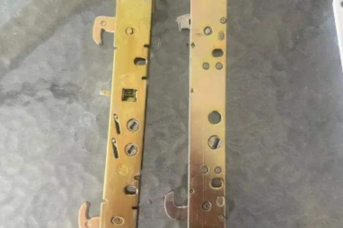 Old and replacement sliding door mortise lock mechanisms side by side