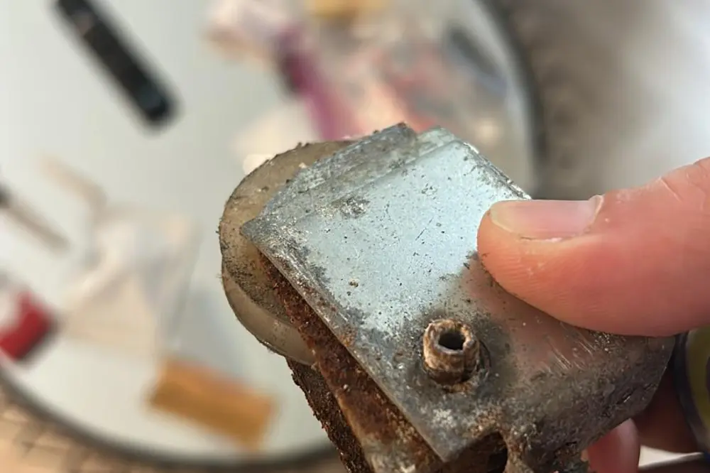 A rusted sliding door roller that lubricant cannot fix