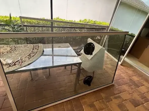Sliding glass panel lifted out of its frame during an off-track repair