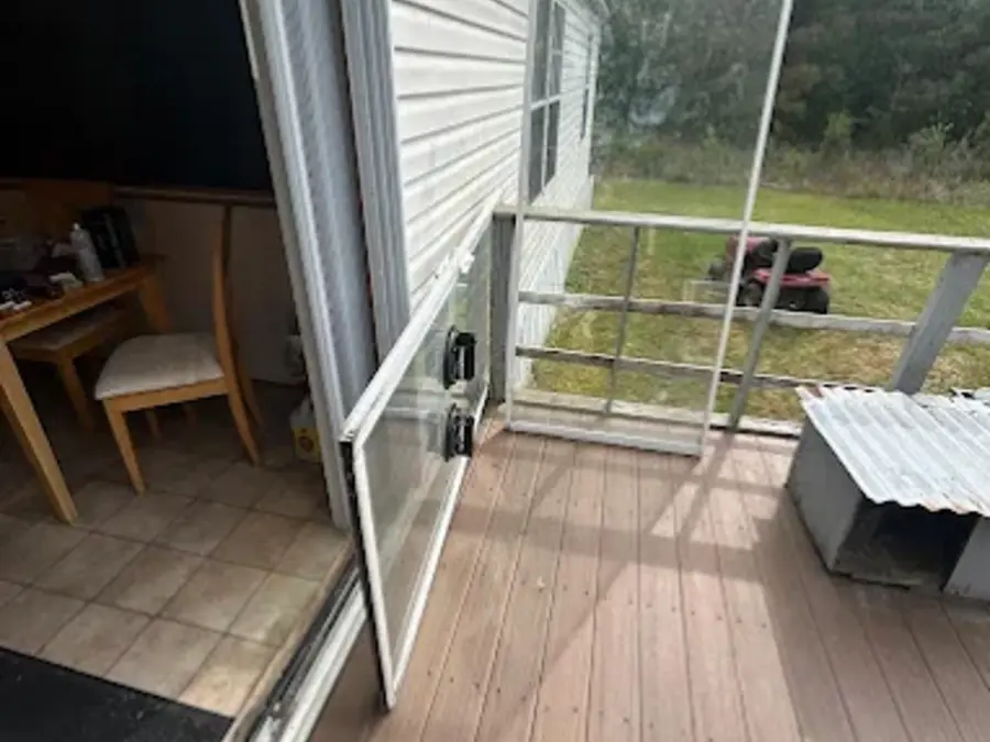 Sliding screen door frame removed for rescreening and roller repair