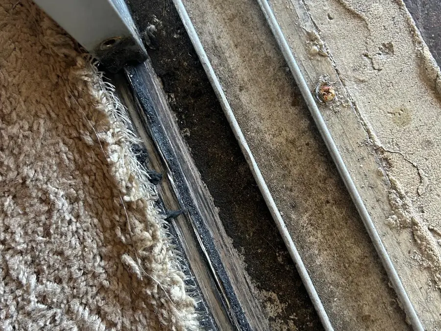 Sliding door track being assessed for repair or replacement